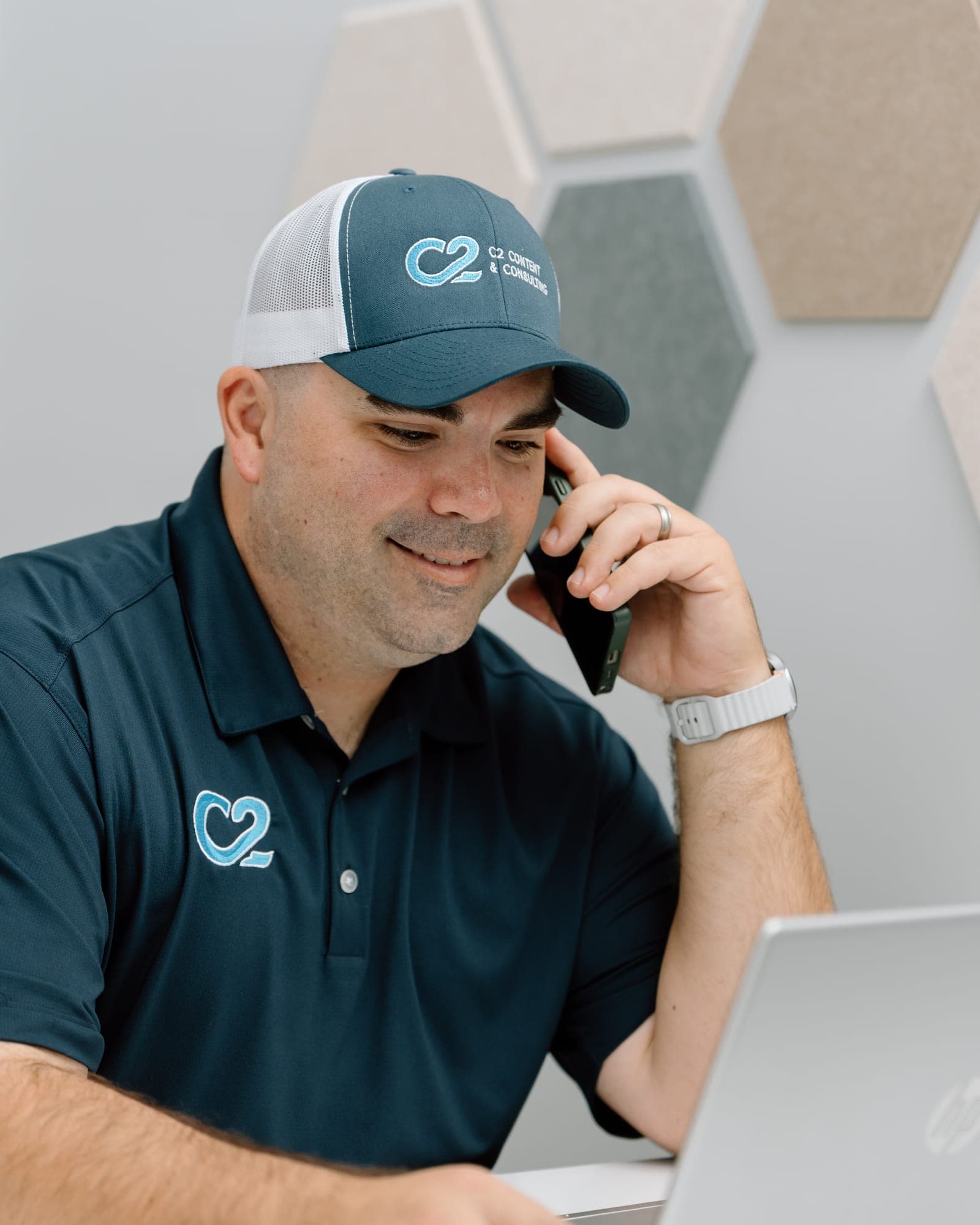 Josh Henderson on a call at his desk